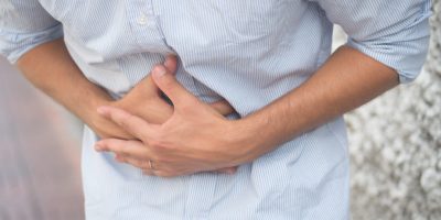 sick man suffers from stomach ache, diarrhea, constipation, indigestion, flatulence; food poisoning